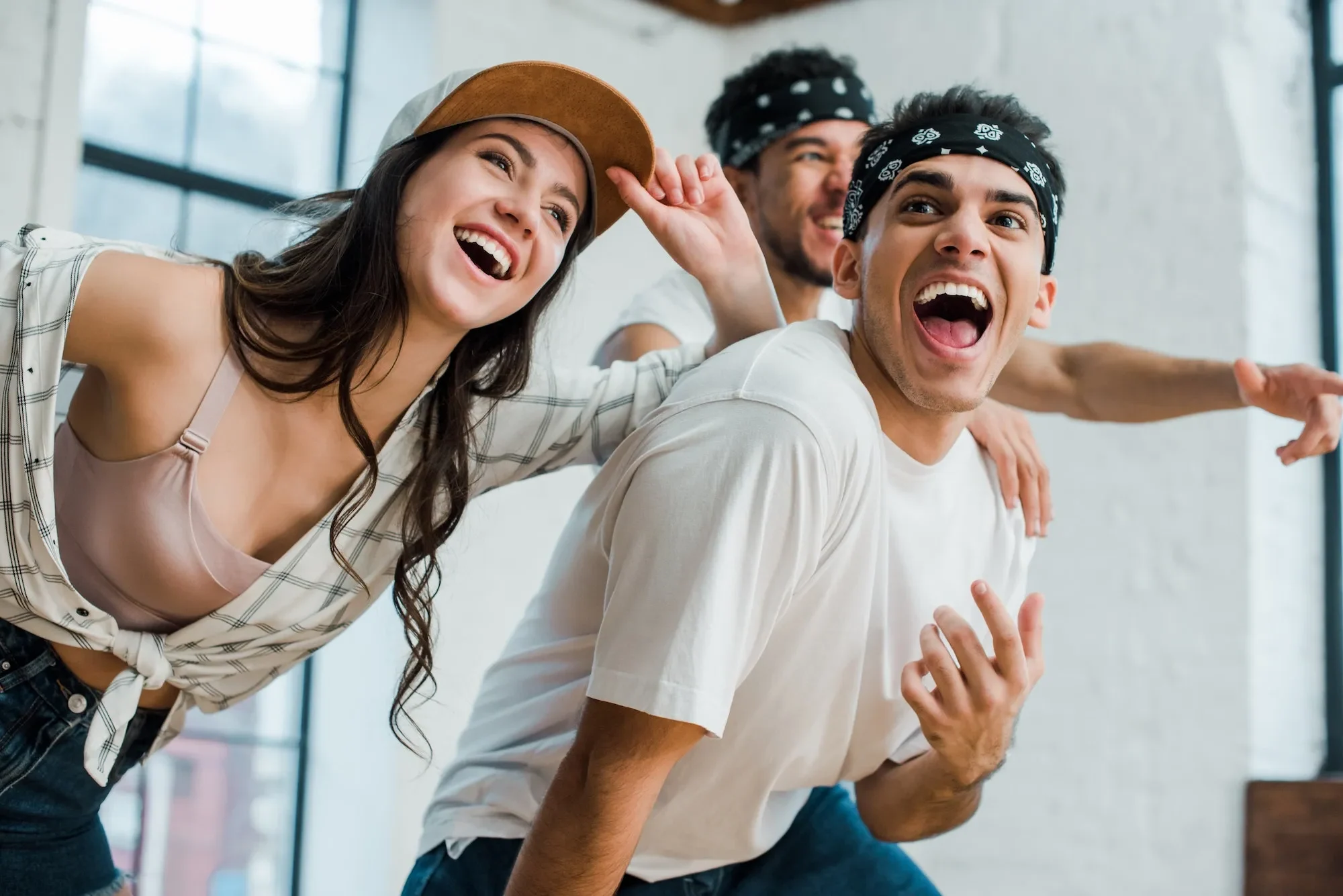 selective-focus-of-cheerful-multicultural-dancers-laughing-in-dance-studio
